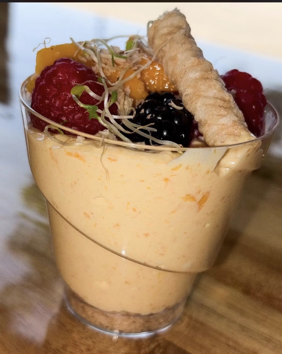 Mango parfait with berries and pastry twist